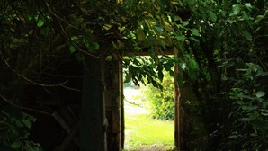 A stone archway leading into a garden.