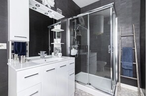 Shower, hair dryer, towels, toilet paper