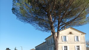 A large stone building with a symmetrical facade, a central entrance, and a well-maintained lawn in front. - House with character, Gardegan-et-Tourtirac (Gardegan-Et-Tourtirac)