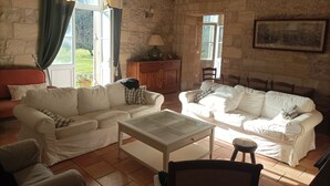 A living room with two white sofas, a glass coffee table, a wooden cabinet, and a painting on the wall. - House with character, Gardegan-et-Tourtirac (Gardegan-Et-Tourtirac)