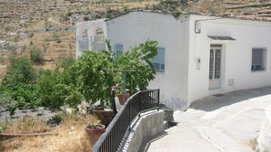 A white building with a small porch and potted plants. - typical house in Spain in ALMERIA, Andalusia 6 people quiet (almeria)