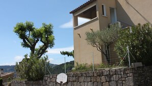 A building with a stone wall, a tree, and a clear sky. - Furnished tourist accommodation 3 * south ardèche with shared pool (Rosières)
