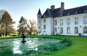 A large, historic building with a symmetrical facade, multiple windows, and a central tower. - Château d'Asnieres en Bessin (Asnieres-en-Bessin)