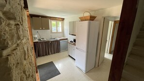 A compact kitchen with white cabinets, a white refrigerator, a microwave, and a small sink. - House with private swimming pool, in the heart of south-west (Thézac)