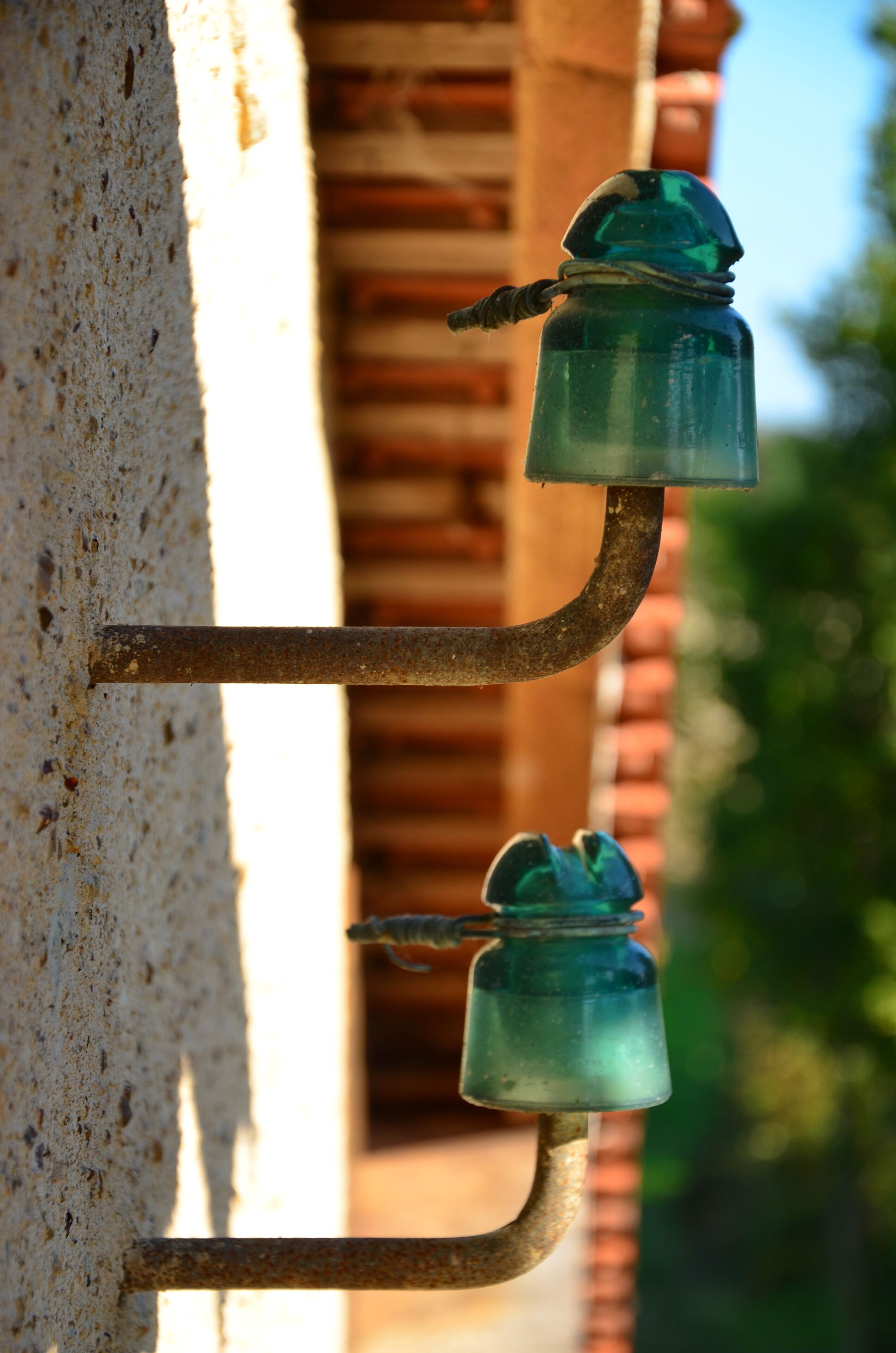 A metal structure with two glass bottles attached to it.