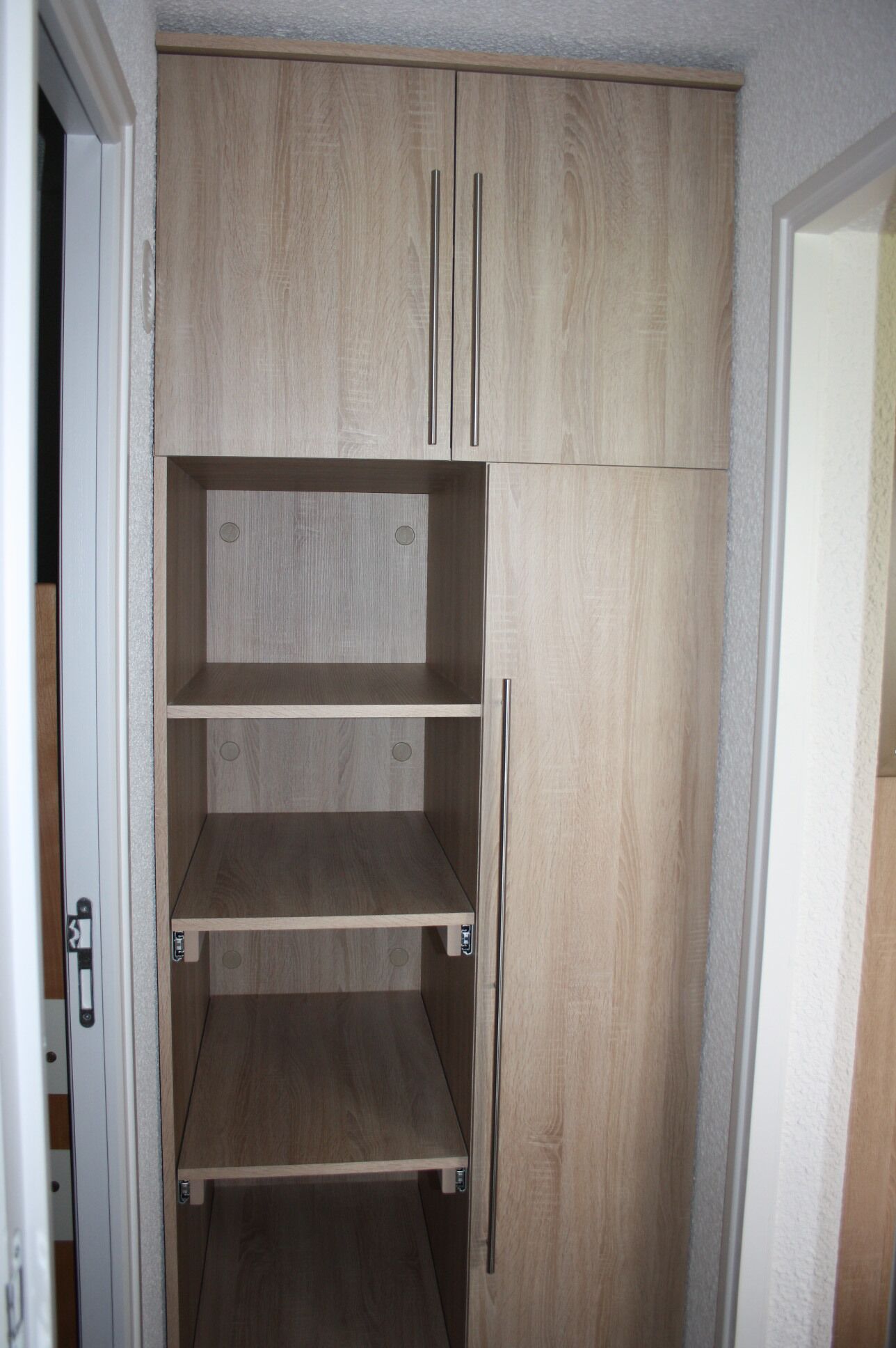 A wardrobe with three shelves and two doors.
