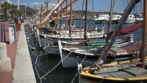 A marina with several boats docked in calm waters.
