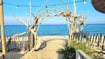 On the beach, sun-loungers