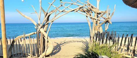 On the beach, sun-loungers