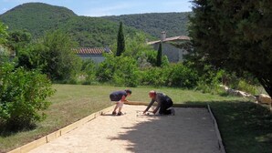 A sandbox with two people playing.