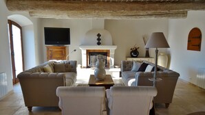 A living room with two sofas, a coffee table, and a fireplace.