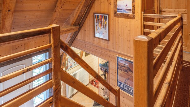 A wooden interior with a wooden staircase, wooden walls, and a poster on the wall. - 🌟Parenthèse nature en Auvergne: Maison typique au panorama exceptionnel-10 pers (saint- sauves d'Auvergne)