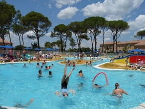 A swimming pool area with multiple pools, lounge chairs, and umbrellas. - Residence in the Mas des Vignes area, 2 swimming pools, parking, 6 people (Calvisson)