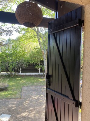 Enter a serene oasis through this charming gate, surrounded by lush greenery and natural beauty.