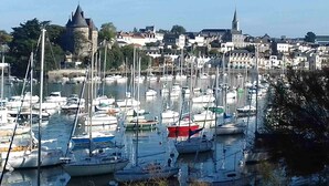 A marina filled with various boats, a castle-like building, and a church in the background. - Fully renovated house, all comforts, near beach, free wi-fi access.  (La Bernerie-En-Retz)