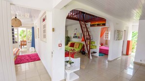 A spacious living area with a staircase, a sofa set, and a dining table. - Luxury karukera villa in st-francois with private pool tel0690071415 (saint-francois)