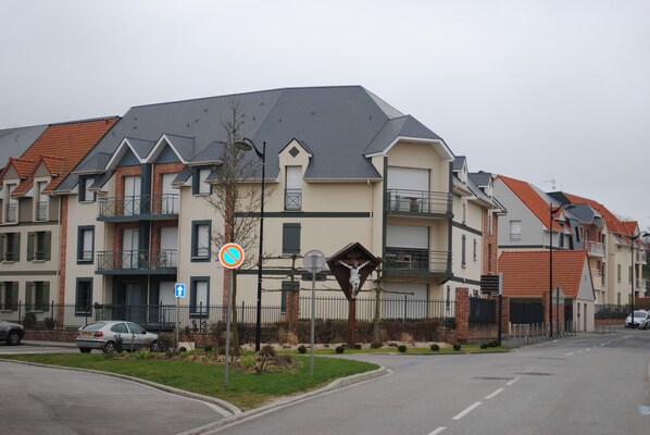 A multi-story residential building with a modern architectural design, featuring balconies and a gated entrance. - Apartment rental in SAINT-VALERY-SUR-SOMME (Saint-Valery-Sur-Somme)