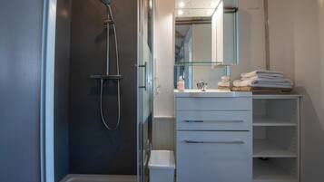 Shower, hair dryer, slippers, towels