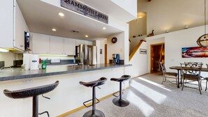 A modern kitchen with a stainless steel refrigerator, a coffee machine, and a sign indicating the location as Mammoth Lakes. - Snowcreek #880 3 Bedroom Condo by RedAwning (Mammoth Lakes)