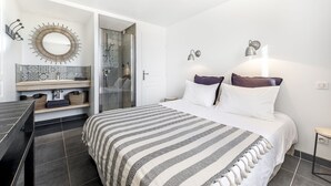 A modern bedroom with a large bed, a shower area, and a vanity with a mirror. - Loft in Provence in Moustiers Sainte Marie and near the Sainte Croix Lake (Moustiers-Sainte-Marie)