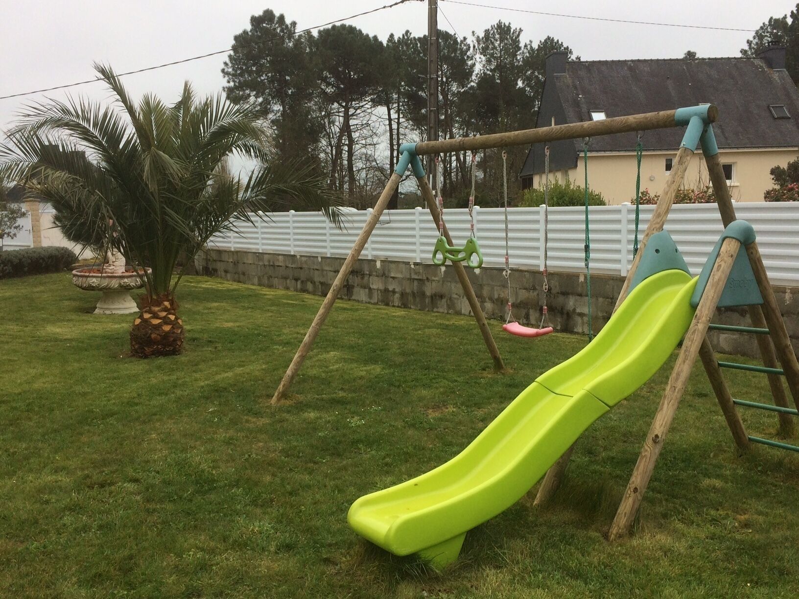 A playground with a slide and swings.