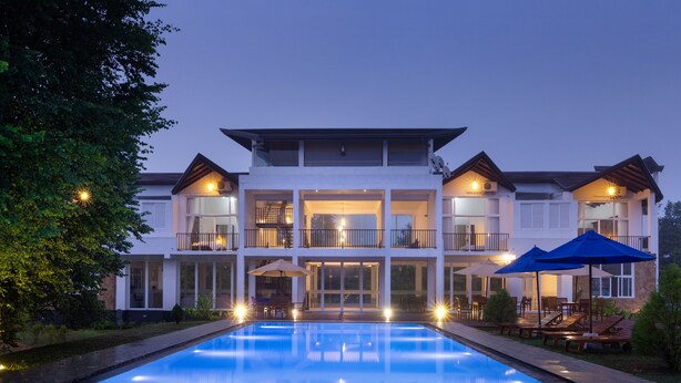 A modern two-story building with a swimming pool in front. - Subaseth Villa (Nuwaragam Palatha Central)