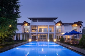 A modern two-story building with a swimming pool in front. - Subaseth Villa (Nuwaragam Palatha Central)