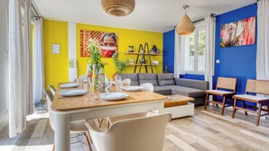 A dining area with a wooden table, chairs, and a sofa.