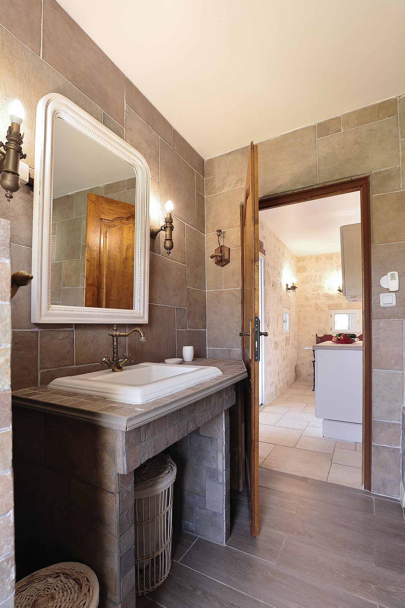 A bathroom with a large mirror, a sink, and a shower area.