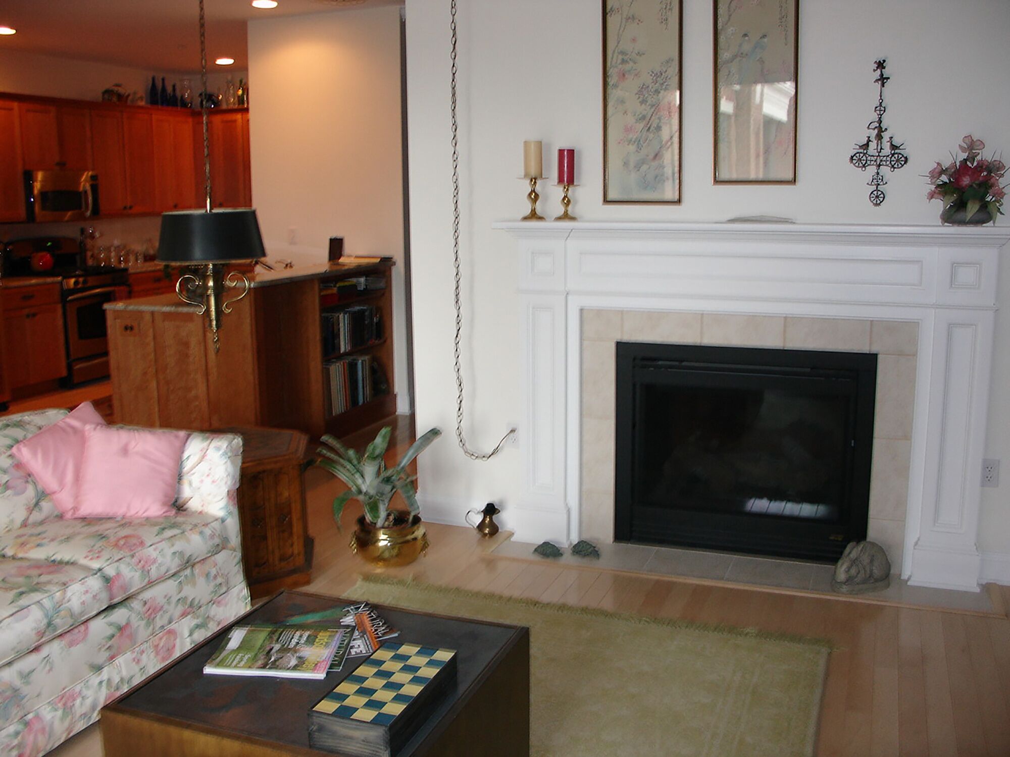 Living room with  two sided fireplace looking into kitchen