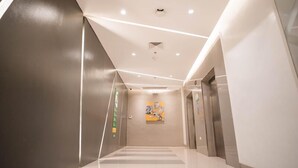 A modern elevator with a digital display, a clean floor, and a wall-mounted artwork. - Go Hotels Iligan (Iligan)