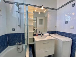 Bathtub, hair dryer, towels, soap