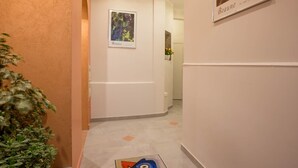 A hallway with a framed picture of grapes labeled "Beaune" and a framed picture of a vineyard. - BSH - Beaune Allerey - Parking included (Beaune)