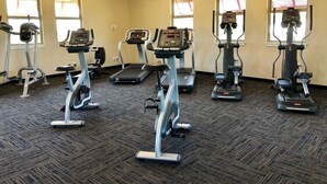 A gym with stationary bikes, treadmills, and elliptical machines. - Luxury condo with central A/C and golf and ocean views (Koloa)