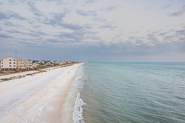 A beach with a row of buildings along the shore. - The Best Kept Secret on the Gulf =Newly Renovated 3BR St. Joe Beach House. (St Joe Beach)