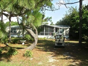 Enjoy an outdoor living space on the screened porch, perfect for relaxing amidst the natural surroundings.