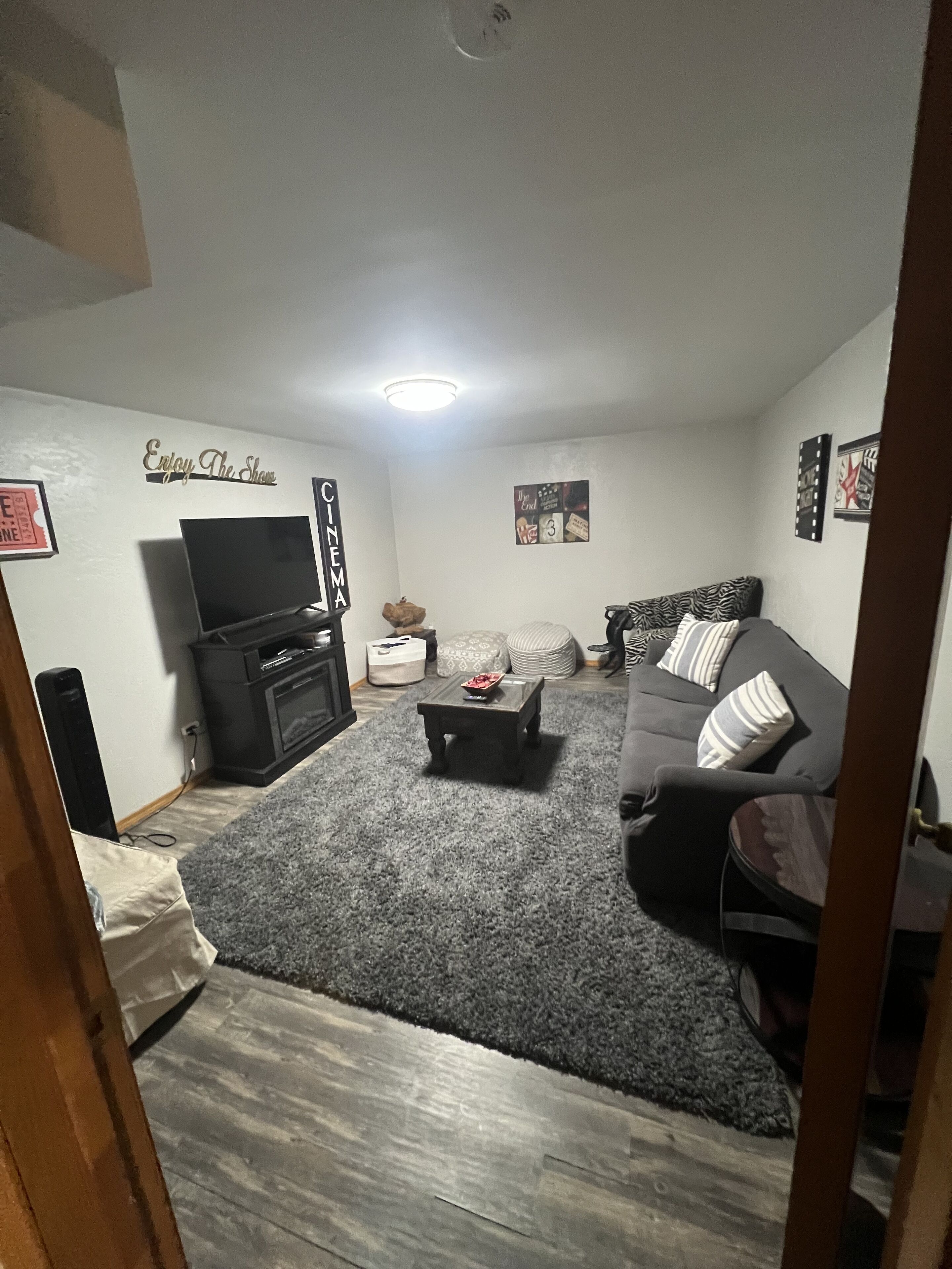 cozy downstairs living room with an electric fireplace