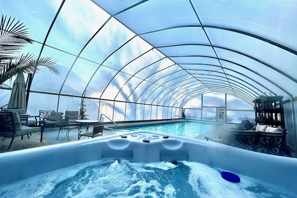 The heated pool and hot tub are fully enclosed for winter swimming.