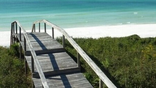 A wooden boardwalk leading to a beach with clear turquoise water and white sand. - 5-bedroom Home just 4.5 min walk to Dedicated Private Beach & 2 community pools (Santa Rosa Beach)