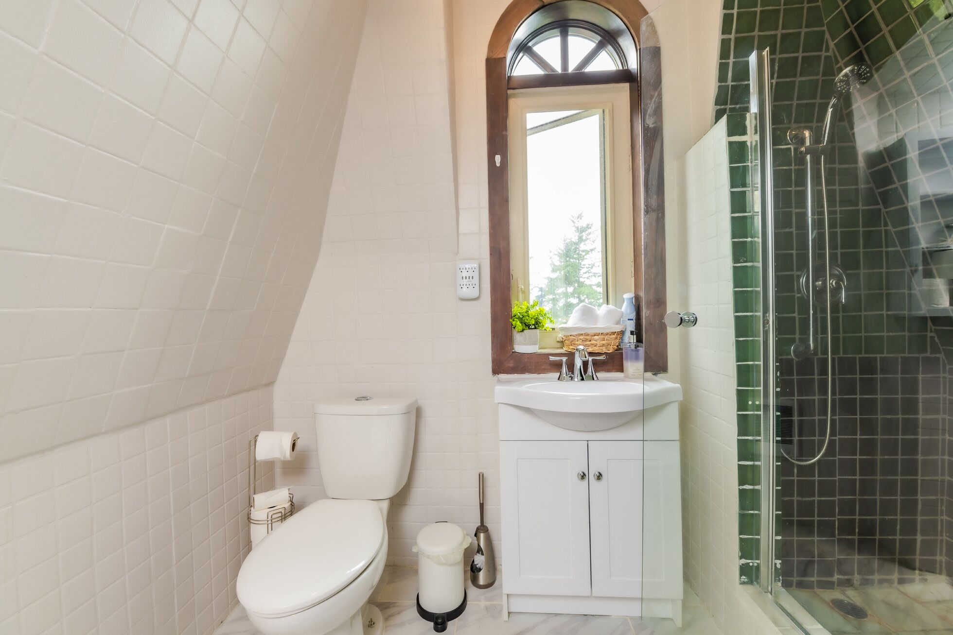 A bathroom with a toilet, sink, and shower.