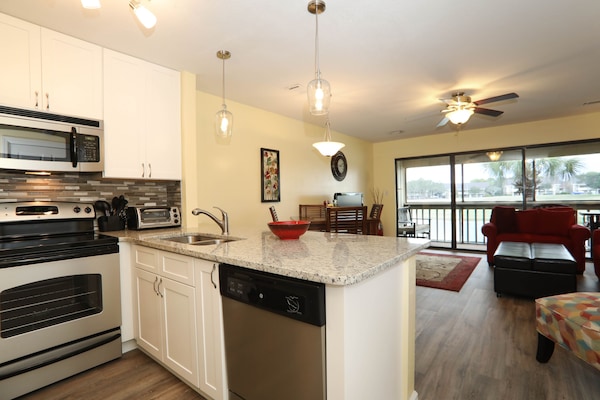 From kitchen to living room and screened in deck beyond