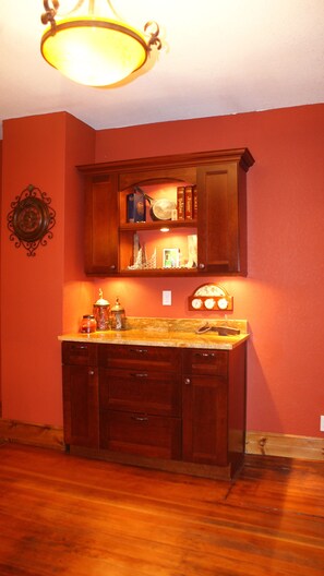A kitchen with wooden cabinets, a countertop, and a hanging light fixture.