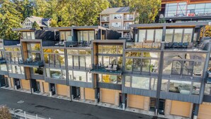 A modern multi-story residential building with large windows, balconies, and a flat roof. - Best spot in town! Modern townhome, downtown Hood River, big views! (Hood River)