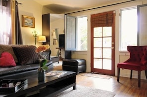 Relax in this stylish living room with a comfortable sofa, armchair, and coffee table.