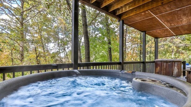 A hot tub under a wooden pergola surrounded by trees. - Summers' Ridge by Mountain Oasis | Dog-Friendly Cabin in Coosawattee River Resort (Ellijay)