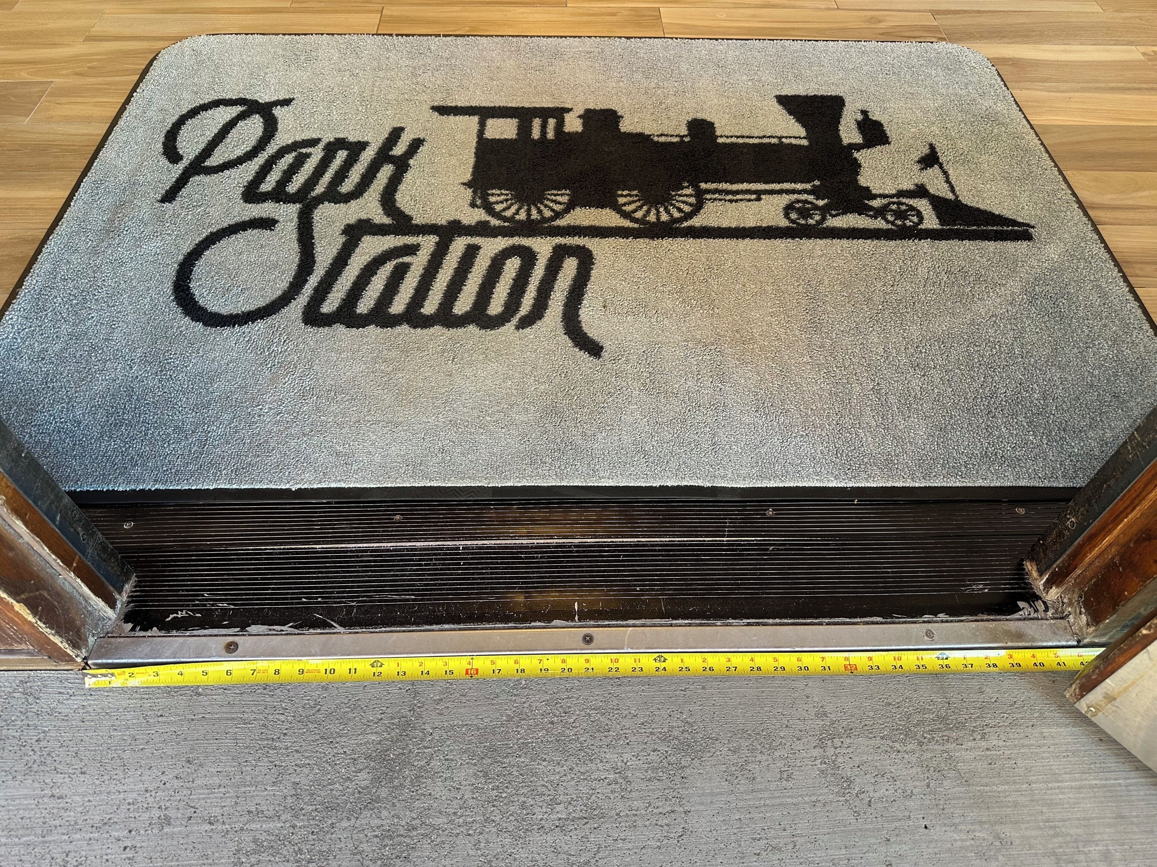 A carpet with a train and the words 'Park Station' on it.