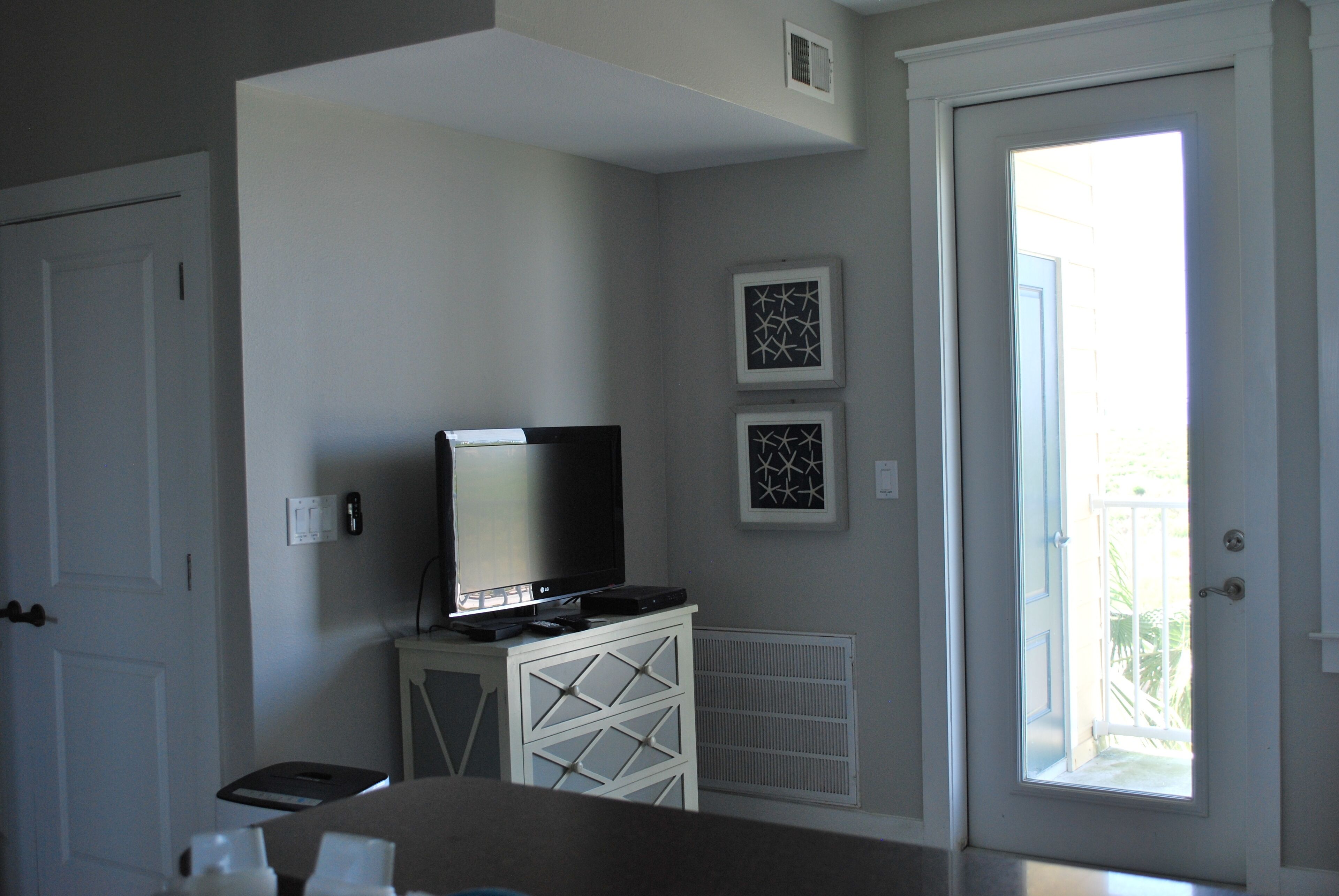 TV in nook by kitchen where guests can stretch out and stay on a sleeper sofa.