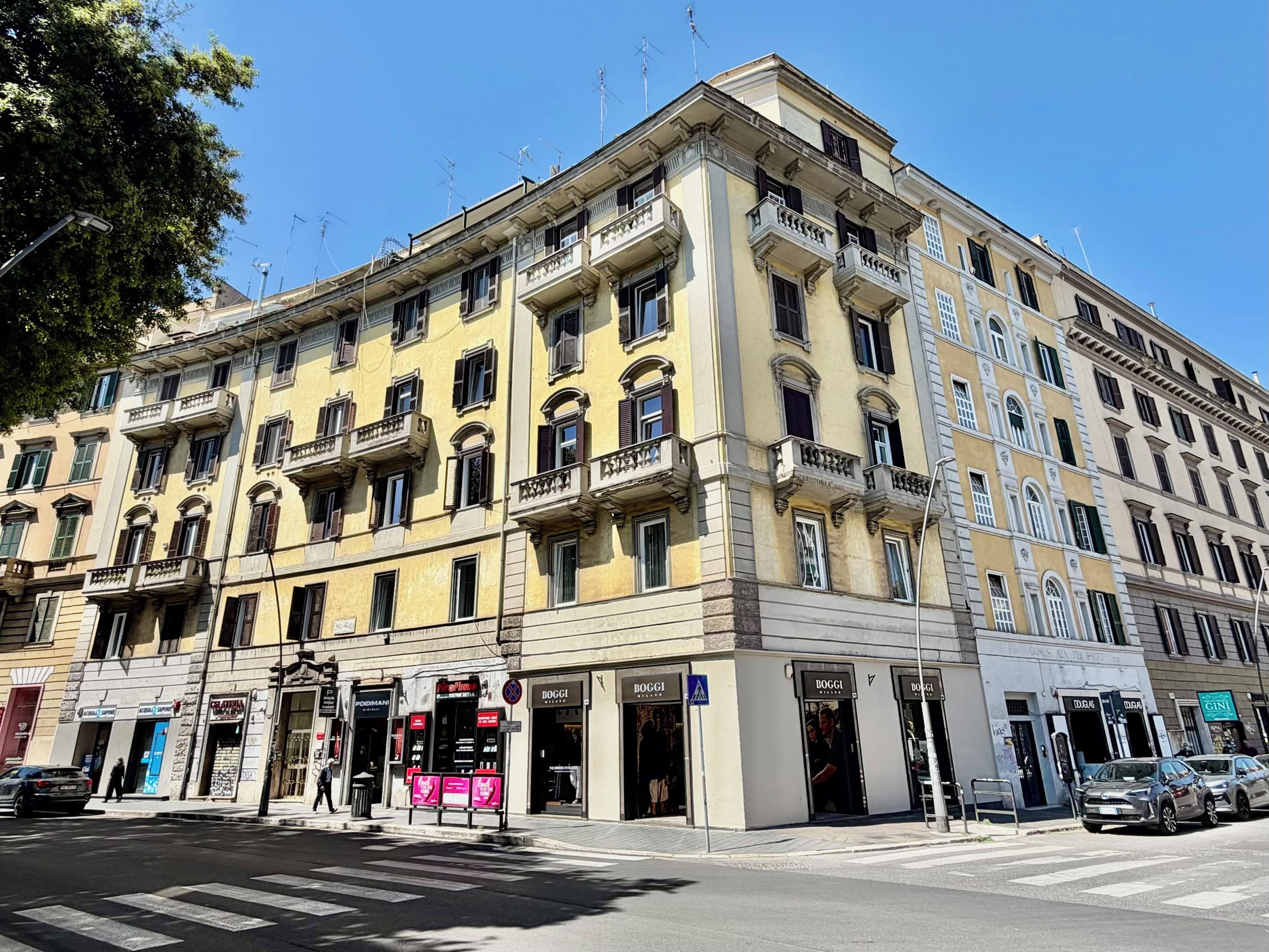 A multi-story building with a classic architectural style, featuring balconies and large windows.