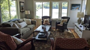 A living room with a sofa, two armchairs, a coffee table, and a TV stand. - Lakefront Home On Beautiful Donnells Pond,32 miles From Acadia N P and Bar Harbr (Franklin)