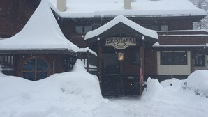 A snow-covered building with a sign reading "Kristianna Condominiums."